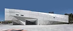 From the plaza, visitors enter the $55 million addition through doors tucked into its folded form