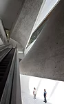 The poured-in-place concrete form of the Lightfall can be seen by visitors as they move around the central atrium space.
