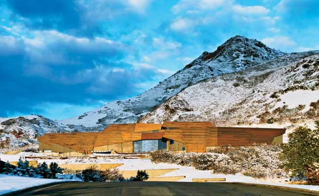 The museum, which sits in the foothills of the Wasatch Mountains at the edge of the University of Utah campus, is clad in panels made of three different copper alloys. Each is patinating differently,