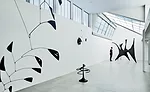 In renovating old roof sheds, Goto removed interior partitions and replaced wire glass with translucent sandwich panels, but kept the skylight angles and shed profiles. Original connections such as bo
