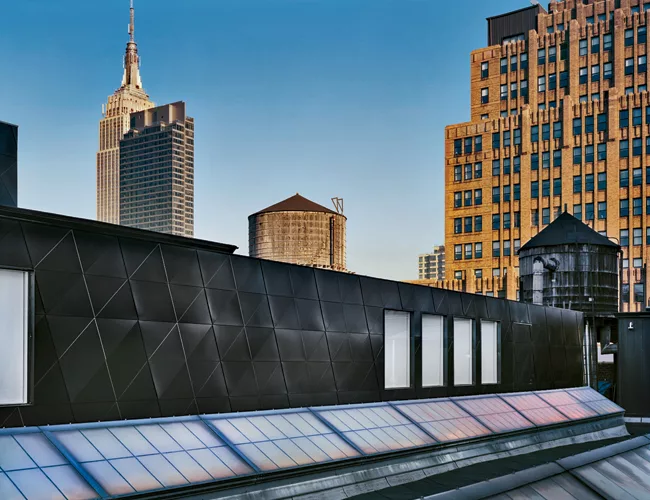 Stainless steel panels that reflect just blue light give the exterior an aura of mystery and offer little hint at what lies inside.