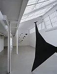 The first gallery has angled skylights, which give it the feeling of a Parisian garret.