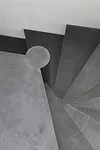 A new stair to a private office is made of raw steel and is the only new element that is not white or off-white.