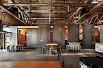 <strong>Open Office</strong> Steel panels slide to adjust the visibility of a workspace from a public tasting room and to regulate the amount of daylight coming in from existing skylights in the forme