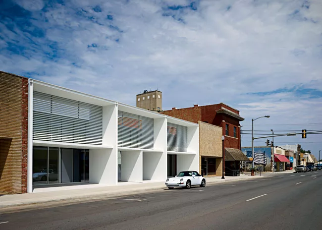 In homage to the original masonry, the brise-soleil’s powder-coated aluminum tubes, like standard brick, are 2 3/8 inches high.