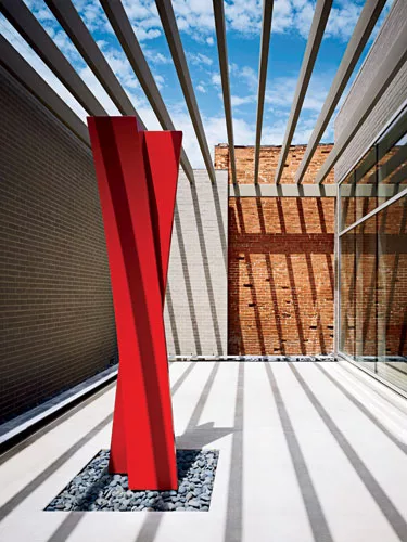 <strong>Back Porch</strong> The rear of the building opens out onto a patio with a sculpture by UK artist Nigel Hall. Kirkpatrick’s chairman, who is also an art collector and chairman of the boa