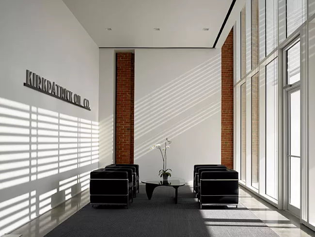 <strong>Community Lounge</strong> Just beyond the dramatic entry through the brise-soleil, the reception area provides a quiet pause before the procession down the central hall. The architect has left