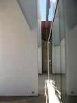 Original party walls are visible through the gap between the brise-soleil and the building facade.