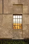 Seen from the Parkway facade, the rooms are framed within the wood-mullioned windows set in Negev limestone.