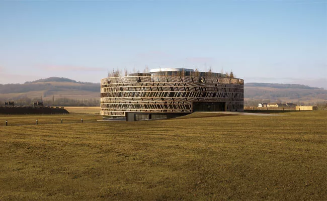 2,060-year-old battlefield On the site where Julius Caesar laid siege to Gallic leader Vercingetorix, Bernard Tschumi has created a circular concrete orientation center wrapped in a wood lattice.
