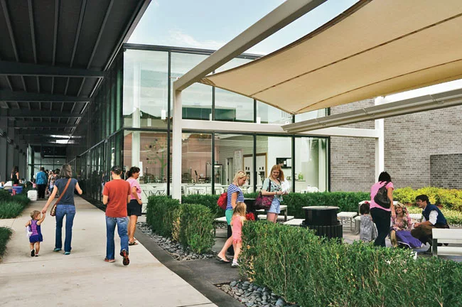 Courtyards tucked between buildings and protected by tensile awnings provide a place for shoppers to catch their breath.