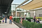 Courtyards tucked between buildings and protected by tensile awnings provide a place for shoppers to catch their breath.