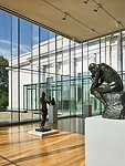 Glass-box galleries sit on top of both the east and west wings' striped bases.