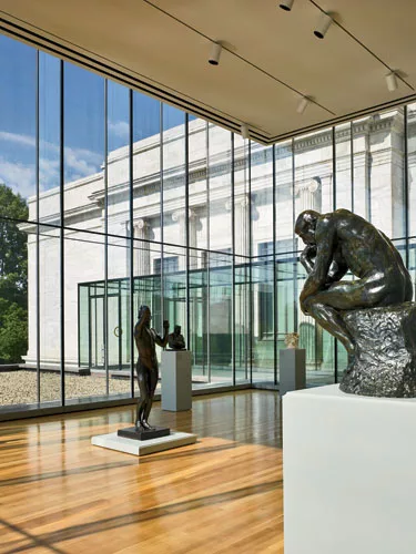 Glass-box galleries sit on top of both the east and west wings' striped bases.