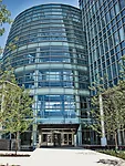 An airy, six-story-high cylindrical atrium serves as the front door to the complex.