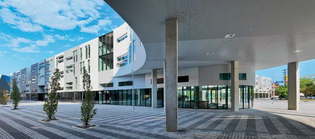 While the buildings line Euclid, they avoid uniformity with playful window patterns, ribbed aluminum facades that cast varying shadows, and plazas with landscape design by James Corner Field Operation