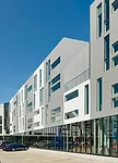 Parking for the ground-level amenities, like a Barnes & Noble and grocery store, is located behind the buildings.