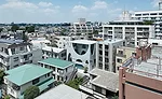 A curl of molded concrete connecting all four levels, a spiral stair stands on the building's south side'the most desirable place for an entrance in Japan. Mirroring the elliptical arches on the facad