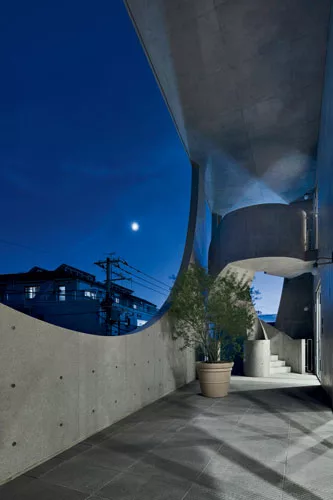 Outside the owner's duplex, the large openings frame a covered, L-shaped terrace enclosing the living/dining room on the third floor.