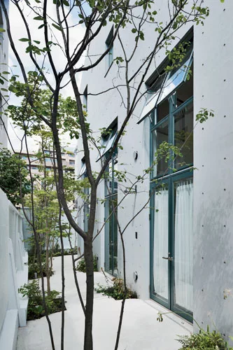 Keiko + Manabu infused the building with interior-design techniqes: A garden walk adds charm to the rental apartments.