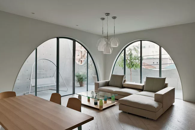 Custom-designed furniture, like a glass-topped coffee table bolstered by buoys, gives the client's duplex a unique style.