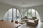 Custom-designed furniture, like a glass-topped coffee table bolstered by buoys, gives the client's duplex a unique style.