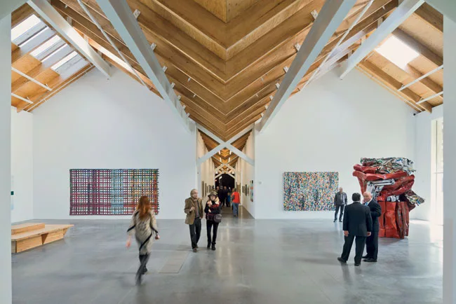 To manage rainwater and snow melt, the designers concealed primary and backup pipes in the X-braces that cross the building's central spine; the pipes deliver water to a belowground infiltration syste
