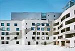 The bright colors of the waste-porcelain chips that make up the pattern on the building's curved white concrete facade were dictated by the production run at the local Arabia factory. The porc