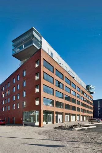  At street side, an arcade in the red-brick front gives the impression of a public building while protecting entrances to the private spaces