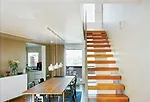 The duplex apartments on the building's uppermost level feature abundant natural light, balconies, and sea views