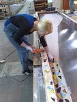 The ceramic chips were glued onto a membrane on the steel frame for the courtyard's concrete panels.