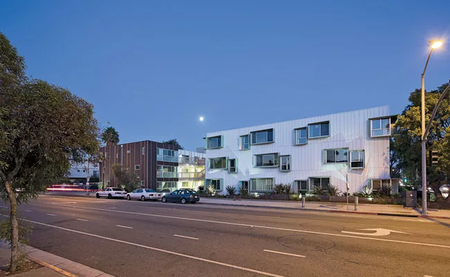 Though sited along an urban thoroughfare, the complex turns inward to a central courtyard.