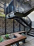 Water-jet-cut Cor-Ten steel with an ornate pattern enlivens balcony fronts and fencing.