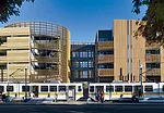 Built by Domus Development, the 63-unit structure is composed of two rectilinear blocks linked at the middle by an elevated-walkway system over a former alley. Recyclable polyvinylchloride siding shea
