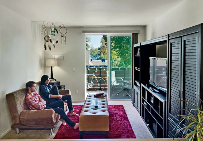 The balcony gives a sense of spaciousness to the apartments in the wood-frame and concrete-deck four-story structure.