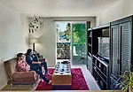 The balcony gives a sense of spaciousness to the apartments in the wood-frame and concrete-deck four-story structure.