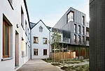 The architects renovated existing 18th- and 19th-century buildings into lofts and apartments, fusing them with new metal-faced dwellings and a colorfully glazed day-care center on a small garden or &l