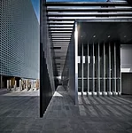The low archives building offers a visual and functional counterpoint to the tall main building.