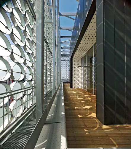 The project earned the Green Building Council of Australia's highest rating at the time it opened, thanks to automated sunshading provided by movable and fixed discs on the main building, as well as p