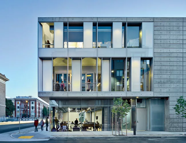 The architects pierced  the poured-in-place-concrete structure with glass window walls so pedestrians standing outside the south facade or the north facade can observe activities within. 
