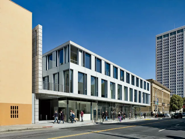 The architects pierced  the poured-in-place-concrete structure with glass window walls so pedestrians standing outside the south facade or the north facade can observe activities within. 