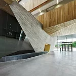 In the lobby, the poured-in-place-concrete structure  looks like an angular tree trunk.
