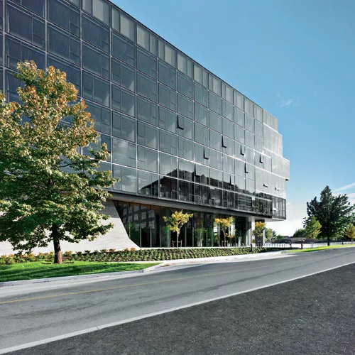 Occupying a corner site on the UBC campus, the rectilinear structure hovers above a base where sleek glass walls alternate with sturdy poured-in-place concrete, as shown on the south facade.