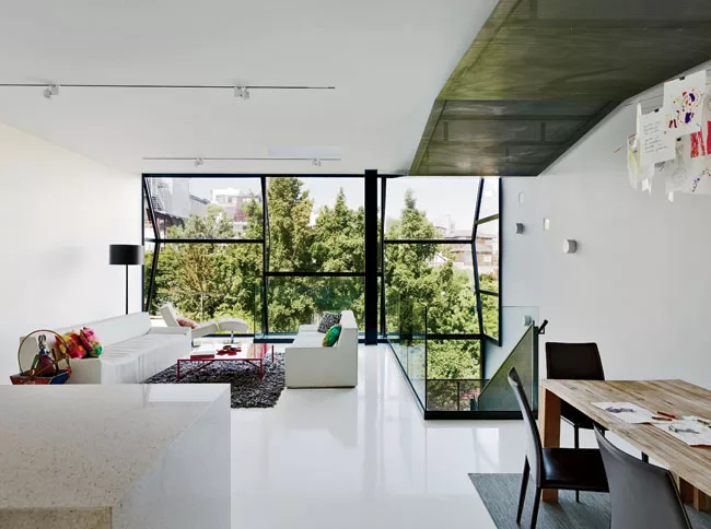 Vertical strips of field glazing' bonded to the frames on site'bring light and views to the living area on the second floor.
