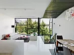 Vertical strips of field glazing' bonded to the frames on site'bring light and views to the living area on the second floor.