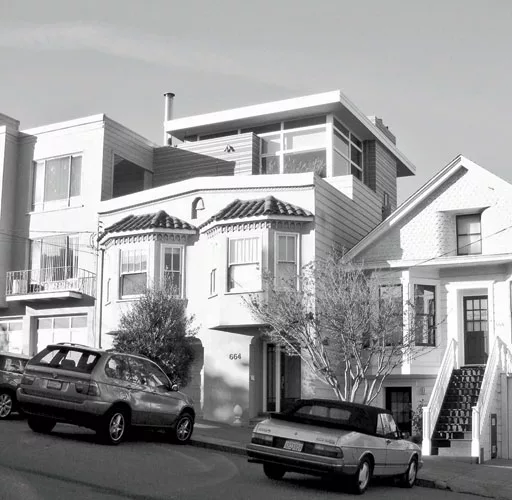 The street facade reveals the master bedroom previously added to the roof, but gives no clue of the striking glazed rear.