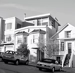 The street facade reveals the master bedroom previously added to the roof, but gives no clue of the striking glazed rear. 