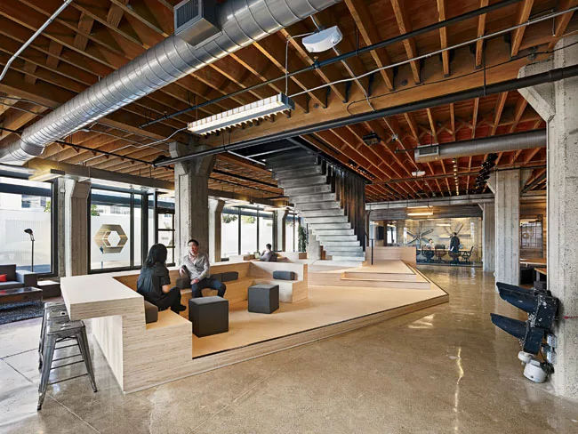 A wood platform serves multiple functions and anchors the lobby's common area.