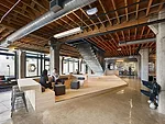 A wood platform serves multiple functions and anchors the lobby's common area. 