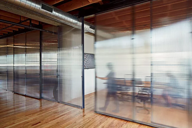 Polycarbonate sheets segment off conference rooms while still letting light through.